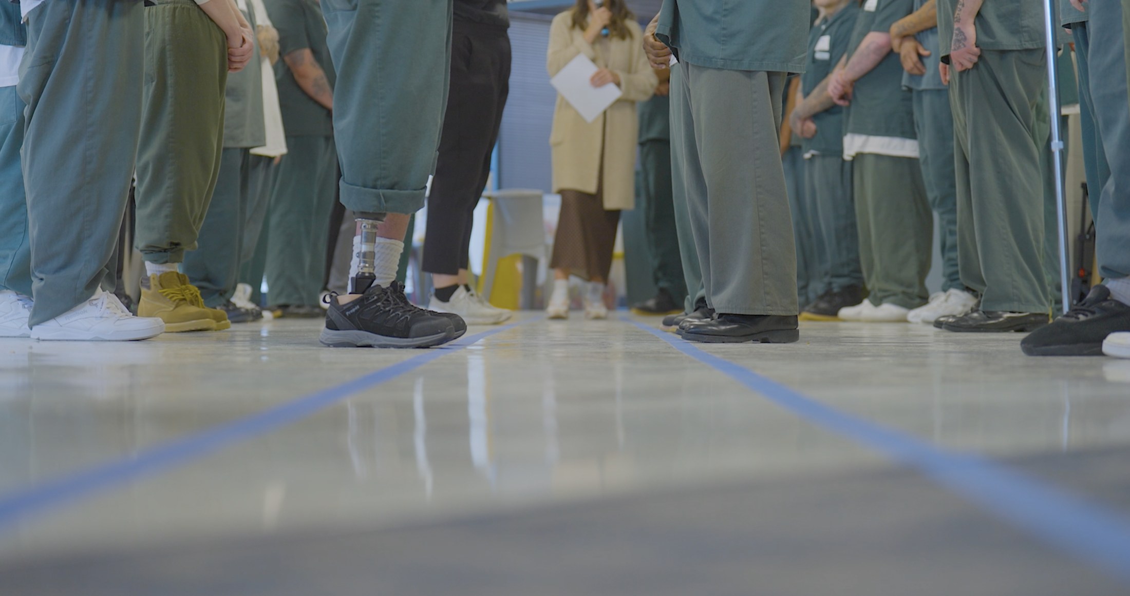 Participants standing together during a Breakthrough activity inside prison